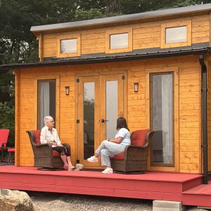 Recent Winner sitting outside her dream Bunkie